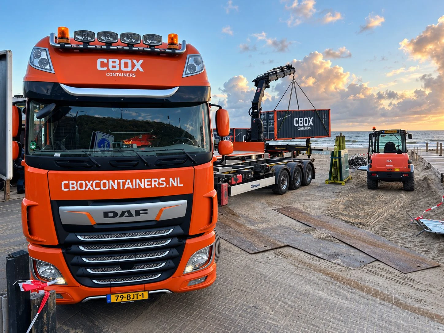 CBOX truck delivering a storage container to a beach pavilion in the Netherlands